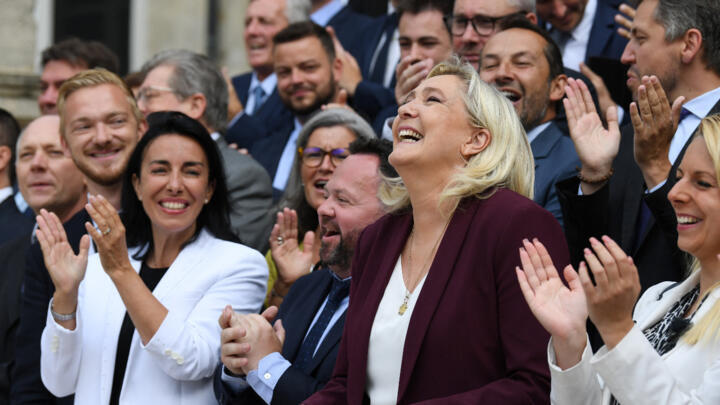 French far-right National Rally leader and MP Marine Le Pen smiles as she arrives for a political family photo at the National Assembly in Paris, on June 22, 2022.